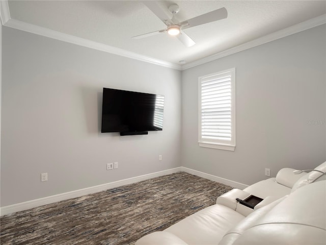 living area featuring wood finished floors, ceiling fan, crown molding, and baseboards