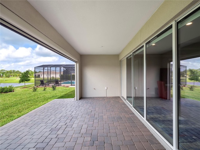 view of patio featuring an outdoor pool and a lanai