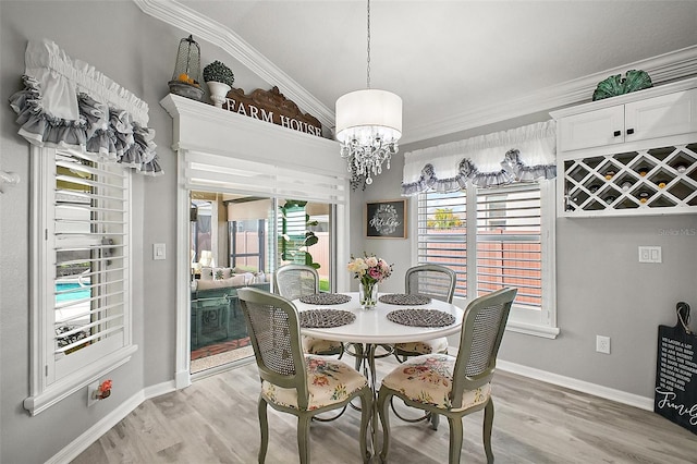 3354 Truluck Pl, Oxford, FL 34484 - dining area with light wood-style flooring, crown molding, a healthy amount of sunlight, and a chandelier