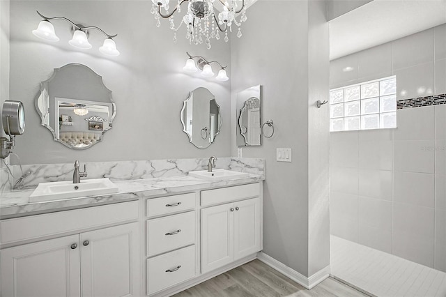 3354 Truluck Pl, Oxford, FL 34484 - full bath featuring a sink, an inviting chandelier, a walk in shower, and wood finished floors
