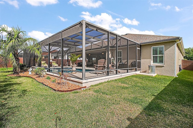 3354 Truluck Pl, Oxford, FL 34484 - back of property with a lanai, stucco siding, a lawn, a fenced backyard, and a patio area