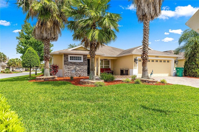 10460 Silver Maple Ave, Oxford, FL 34484 - single story home featuring stucco siding, decorative driveway, an attached garage, and a front yard