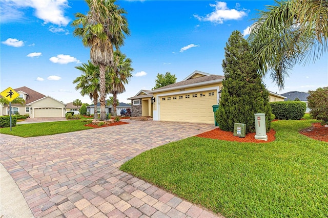 10460 Silver Maple Ave, Oxford, FL 34484 - ranch-style house with decorative driveway, an attached garage, a front yard, and stucco siding