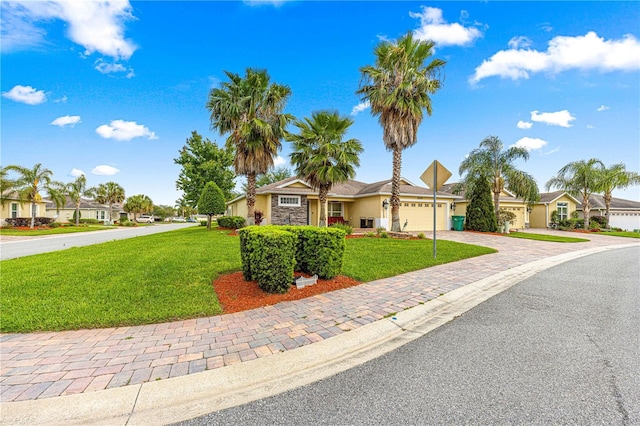 10460 Silver Maple Ave, Oxford, FL 34484 - ranch-style house with a garage, decorative driveway, a front yard, and stucco siding