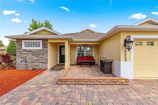 10460 Silver Maple Ave, Oxford, FL 34484 - view of exterior entry featuring stucco siding, an outdoor hangout area, and stone siding
