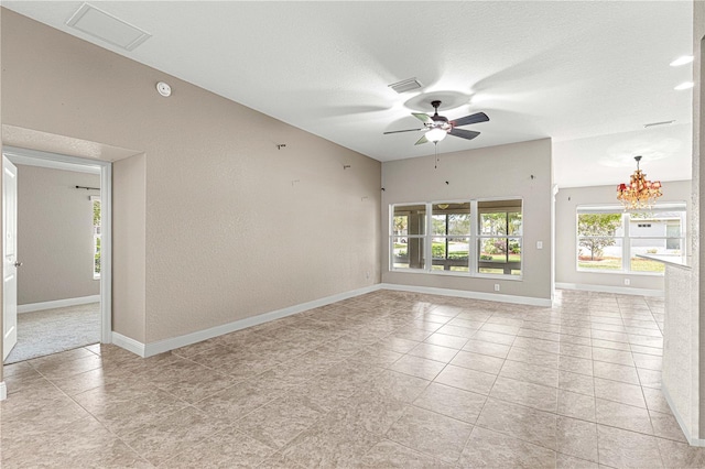 10460 Silver Maple Ave, Oxford, FL 34484 - empty room with healthy amount of natural light, ceiling fan, baseboards, a chandelier, and a textured wall
