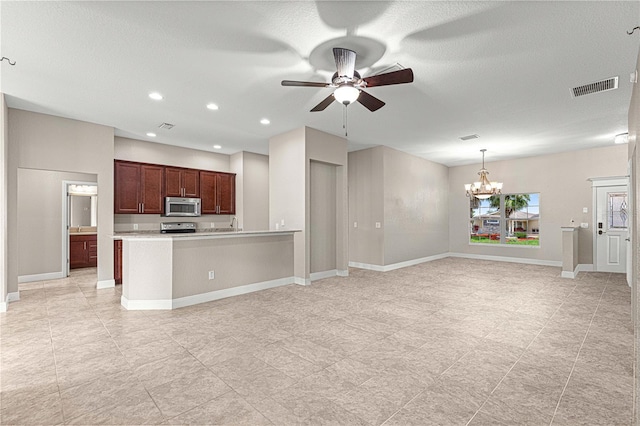 10460 Silver Maple Ave, Oxford, FL 34484 - kitchen featuring appliances with stainless steel finishes, light countertops, a ceiling fan, a chandelier, and open floor plan
