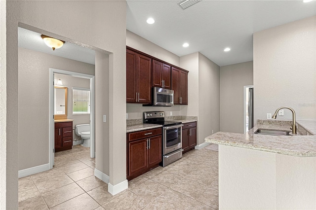 10460 Silver Maple Ave, Oxford, FL 34484 - kitchen featuring stainless steel appliances, a sink, light tile patterned flooring, baseboards, and recessed lighting