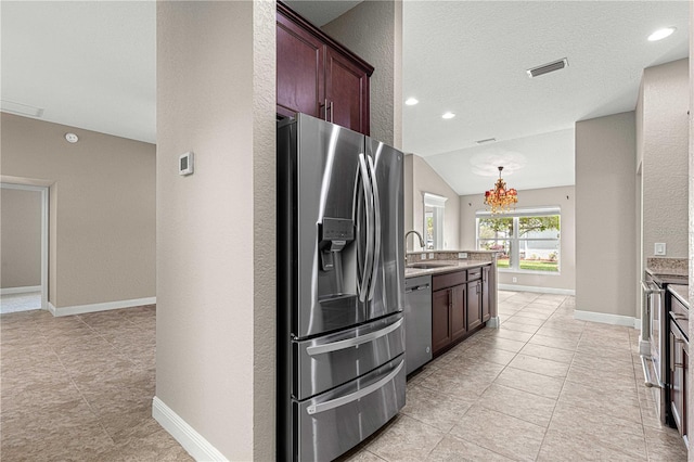 10460 Silver Maple Ave, Oxford, FL 34484 - kitchen featuring appliances with stainless steel finishes, a sink, a chandelier, lofted ceiling, and light tile patterned floors