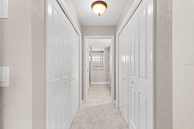 10460 Silver Maple Ave, Oxford, FL 34484 - corridor with a textured wall, carpet flooring, and a textured ceiling