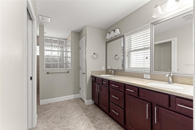 10460 Silver Maple Ave, Oxford, FL 34484 - full bath with double vanity, a textured ceiling, tile patterned flooring, and baseboards