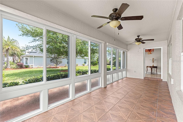 10460 Silver Maple Ave, Oxford, FL 34484 - unfurnished sunroom featuring ceiling fan, a textured ceiling, and a textured wall