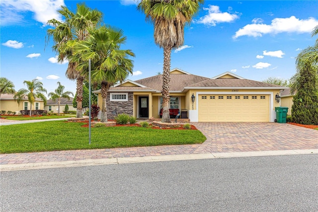 10460 Silver Maple Ave, Oxford, FL 34484 - single story home featuring an attached garage, a front lawn, driveway, and stucco siding