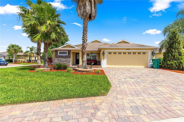 10460 Silver Maple Ave, Oxford, FL 34484 - single story home featuring decorative driveway, an attached garage, a front yard, and stucco siding