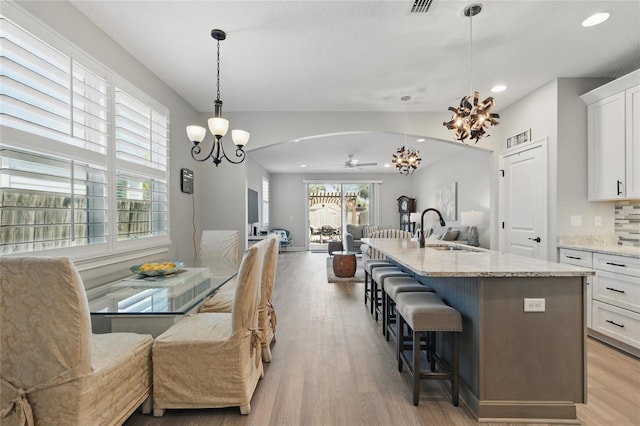 411 S 5th Ave S, Jacksonville Beach, FL 32250 - kitchen with open floor plan, white cabinets, a sink, and plenty of natural light