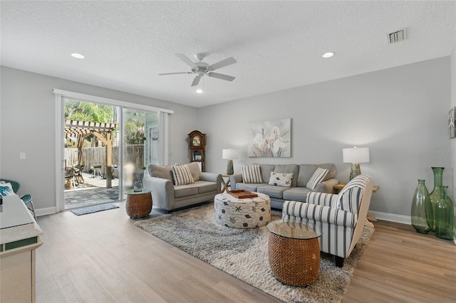 411 S 5th Ave S, Jacksonville Beach, FL 32250 - living area with baseboards, a textured ceiling, visible vents, a ceiling fan, and wood finished floors