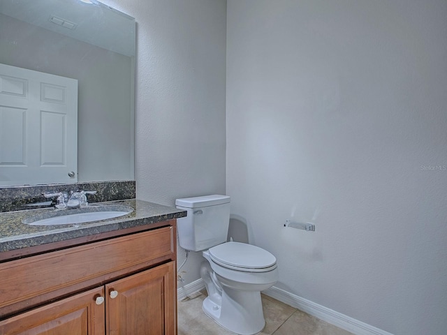 bathroom featuring vanity, tile patterned flooring, visible vents, toilet, and baseboards