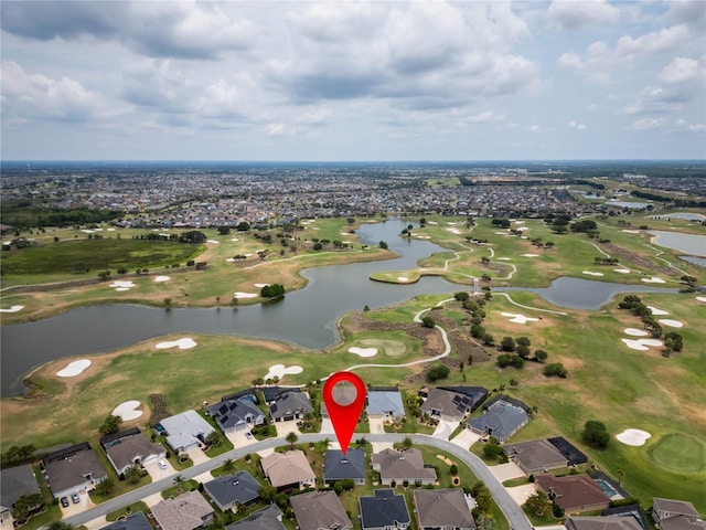 aerial view of property and surrounding area featuring a local golf course, a large body of water, and nearby suburban area