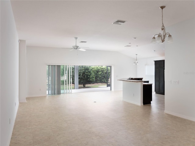 unfurnished living room with a chandelier, ceiling fan, baseboards, and lofted ceiling