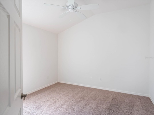 spare room with carpet flooring, lofted ceiling, ceiling fan, and baseboards