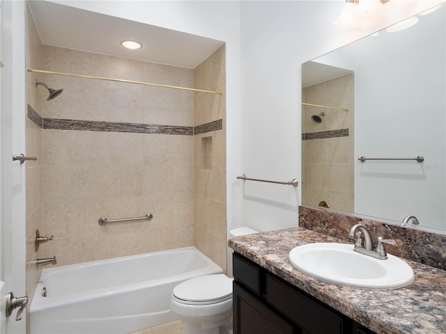 bathroom with toilet,  shower combination, and vanity