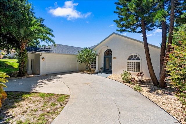 11024 Windchime Cir, Clermont, FL 34711 - view of front of house with stucco siding, a garage, and concrete driveway