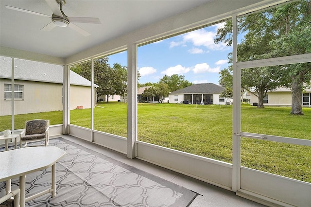 3800 Woodleaf Ct, Leesburg, FL 34748 - sunroom / solarium with ceiling fan, plenty of natural light, and a residential view