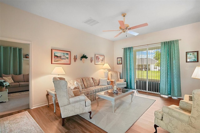 3800 Woodleaf Ct, Leesburg, FL 34748 - living area with wood finished floors, a ceiling fan, and baseboards