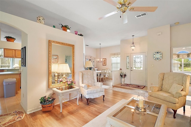 3800 Woodleaf Ct, Leesburg, FL 34748 - living room featuring light wood-style floors, arched walkways, ceiling fan, and baseboards