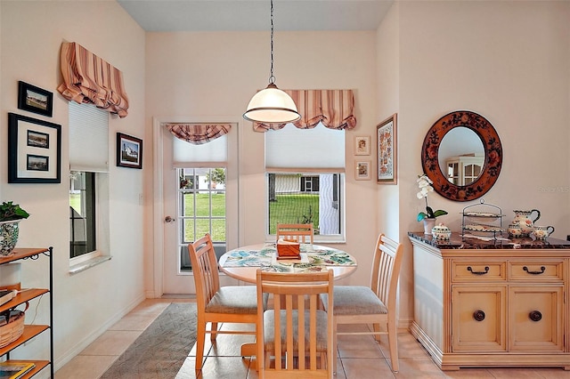 3800 Woodleaf Ct, Leesburg, FL 34748 - dining space with light tile patterned flooring, baseboards, and a high ceiling