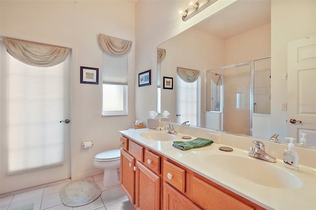 3800 Woodleaf Ct, Leesburg, FL 34748 - bathroom featuring double vanity, a shower stall, tile patterned flooring, and toilet