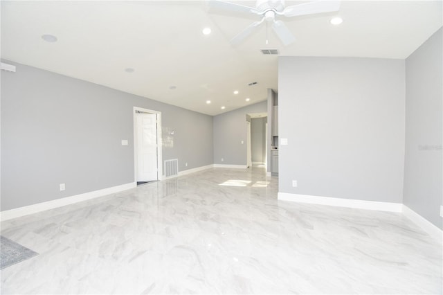 empty room featuring visible vents, baseboards, and vaulted ceiling