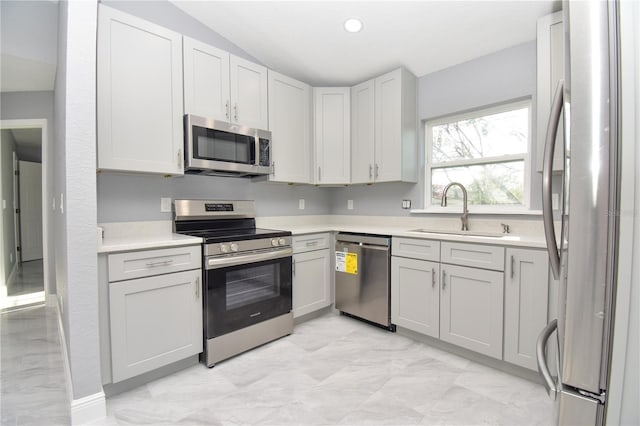 kitchen featuring light countertops, recessed lighting, a sink, and stainless steel appliances