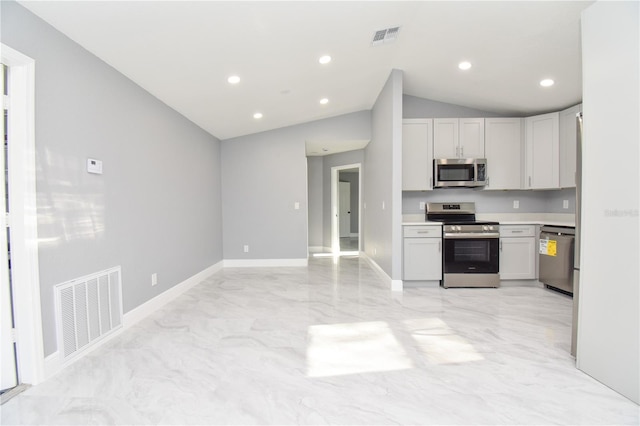 kitchen with stainless steel appliances, visible vents, light countertops, and vaulted ceiling