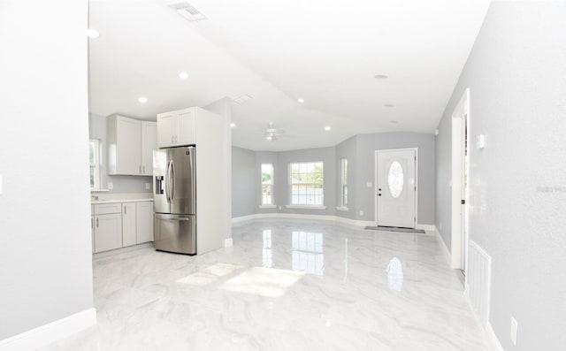kitchen with stainless steel fridge with ice dispenser, visible vents, marble finish floor, and ceiling fan