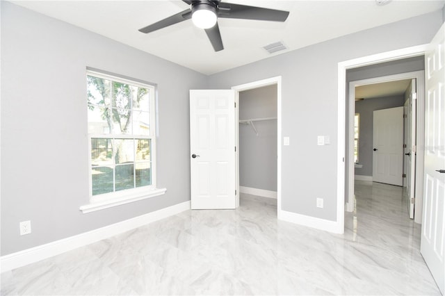 unfurnished bedroom with a closet, a ceiling fan, visible vents, marble finish floor, and baseboards