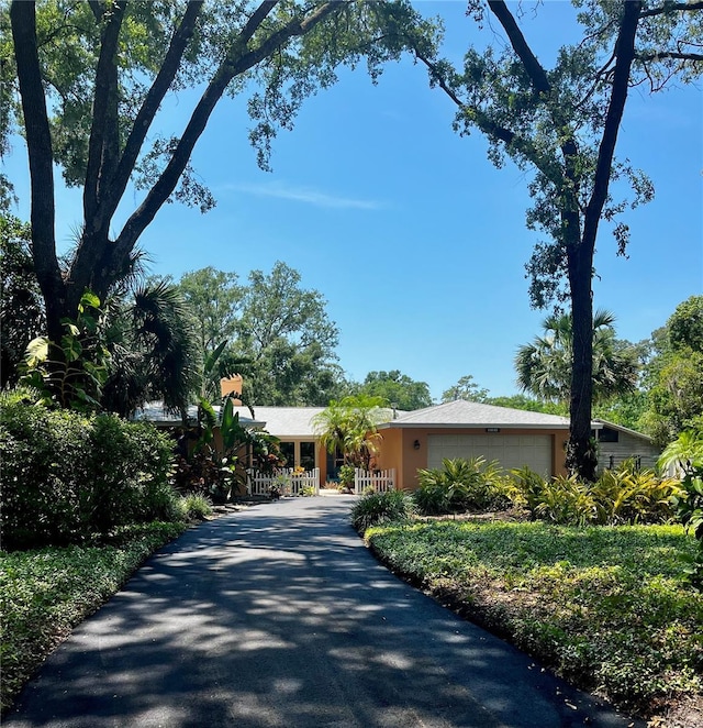 2121 Suzanne Dr, Mount Dora, FL 32757 - view of front of home featuring an attached garage and asphalt driveway