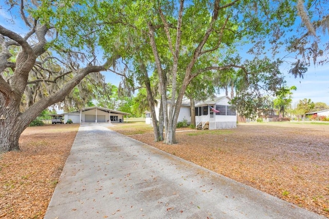 16724 Highland Ave, Montverde, FL 34756 - view of front facade featuring driveway and a carport