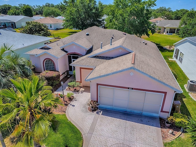 910 Eagles Lndg, Leesburg, FL 34748 - view of front facade featuring a shingled roof, decorative driveway, stucco siding, and an attached garage