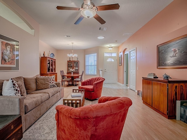 910 Eagles Lndg, Leesburg, FL 34748 - living room featuring light wood-style floors, a chandelier, ceiling fan, and baseboards