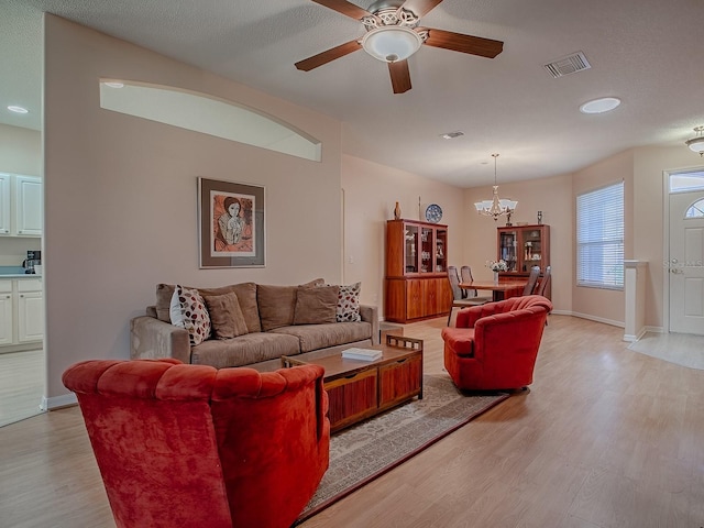 910 Eagles Lndg, Leesburg, FL 34748 - living room featuring light wood-style flooring, a ceiling fan, a chandelier, recessed lighting, and baseboards