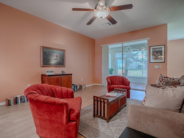 910 Eagles Lndg, Leesburg, FL 34748 - living area featuring ceiling fan, light wood-type flooring, and baseboards