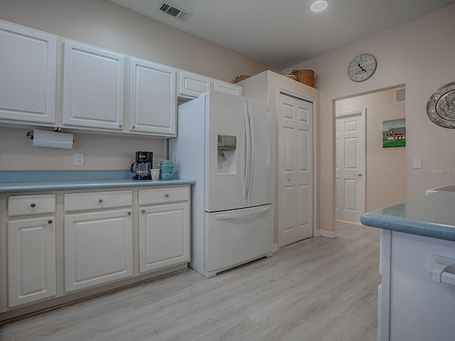 910 Eagles Lndg, Leesburg, FL 34748 - kitchen featuring white refrigerator with ice dispenser, white cabinets, light wood finished floors, and light countertops