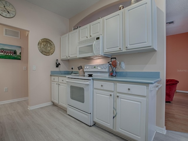 910 Eagles Lndg, Leesburg, FL 34748 - kitchen with white appliances, light wood-style floors, white cabinetry, baseboards, and light countertops