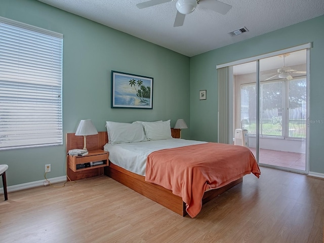 910 Eagles Lndg, Leesburg, FL 34748 - bedroom with access to exterior, light wood-style flooring, baseboards, and a ceiling fan