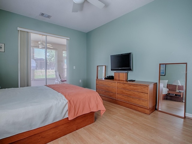 910 Eagles Lndg, Leesburg, FL 34748 - bedroom with access to exterior, light wood-style flooring, and ceiling fan