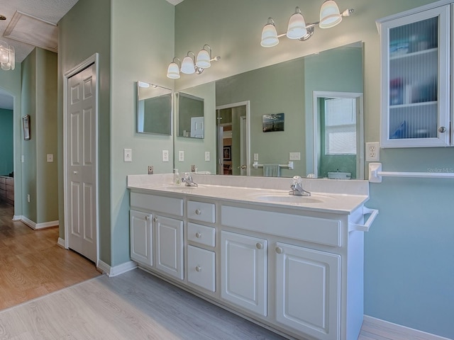 910 Eagles Lndg, Leesburg, FL 34748 - full bath featuring wood finished floors, double vanity, and baseboards