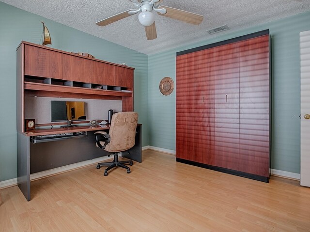 910 Eagles Lndg, Leesburg, FL 34748 - office featuring wood finished floors, a textured ceiling, a ceiling fan, and baseboards