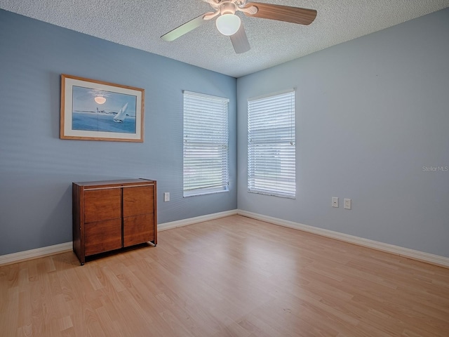 910 Eagles Lndg, Leesburg, FL 34748 - empty room featuring wood finished floors, a textured ceiling, ceiling fan, and baseboards