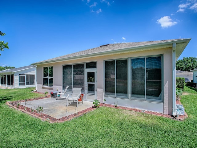 910 Eagles Lndg, Leesburg, FL 34748 - back of house with a patio area, a yard, and stucco siding